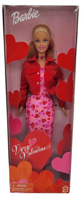 Mattel 2000 Barbie doll called "Very Valentine". Barbie has blonde hair wearing a pink dress with red & pink hearts and a red jacket. The box has red and pink hearts on the inside of the box.