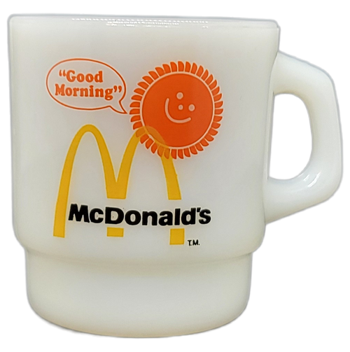 Vintage McDonald's "Good Morning" milk glass coffee cup/mug by Anchor Hocking. The Fire King cup is white with the sun  saying "Good Morning" rising above the McDonald's logo on the one side. The mug stands 3.25-inches tall and 3-inches wide without the handle.