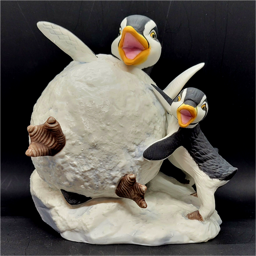 Whoa! figurine features a penguin inside a snowball with 2 penguins beside him. The figurine is a hand painted porcelain figurine crafted in Malaysia. Michelle Emblem's figurine is 6-inches wide by 6-inches tall and 5-inches deep.