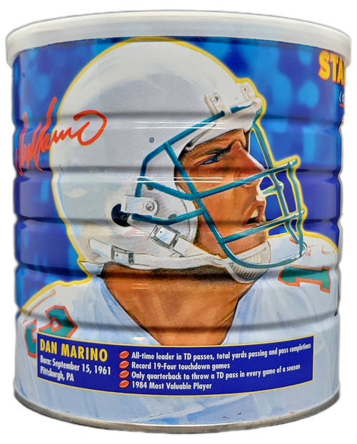 Vintage Maxwell House Master Blend Coffee can collector series of Star Quarterbacks featured on the can. This 34.5 oz can features Dan Marino with one picture featuring Dan Marino in his home jersey dropping back to throw a pass. The opposite side features Dan Marino wearing his away jersey from the shoulders up and some of his bio information under the picture. The can also features a facsimile autograph of Dan Marino.