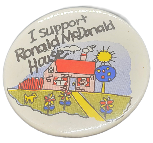 Vintage "I support Ronald McDonald House" 3-inch pin back button featuring a house with dog and bright colored plants. Ronald McDonald House is a nonprofit family & children's charity dedicated to supporting families with sick children in their time of need.