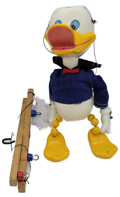 Vintage Pelham Puppets Walt Disney's Donald Duck hand made standard puppet for children. The Donald Duck marionette has a molded composition head with wooden limbs and a cross-shaped wooden control bar with strings. Pelham Puppets were Made in England.