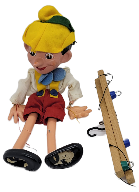 Vintage Pelham Puppets Walt Disney's Pinocchio hand made standard puppet for children. The Pinocchio marionette has a molded composition head with wooden limbs and a cross-shaped wooden control bar with strings. Pelham Puppets were Made in England.