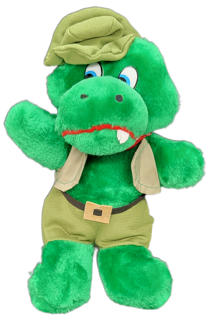 Roni Toy 1987 alligator 9-inch plush wearing safari outfit. The alligator is in a seated position with brown pants, vest and hat. The alligator was Made in Korea.