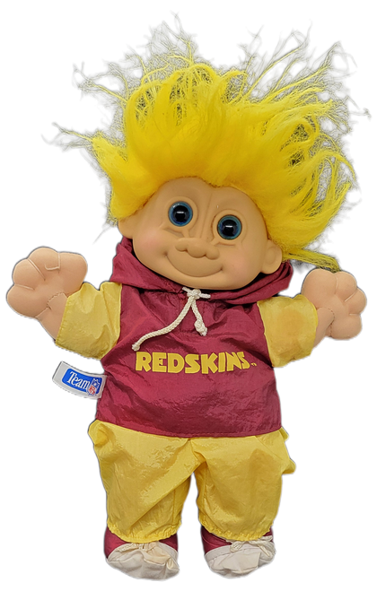 Russ Troll Kidz Team NFL Washington Redskins 10-inch troll doll with yellow hair. The line of trolls are officially licensed and represent all of the teams of the NFL at that time. The troll is wearing yellow wind breaker pants and red wind breaker shirt with yellow sleeves with Redskins in yellow on front.