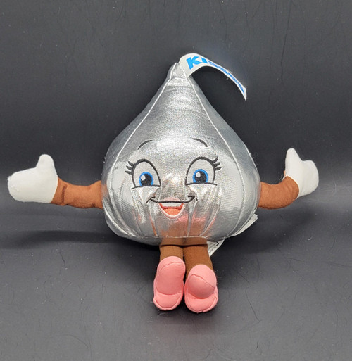 Hersheypark souvenir 6-inch tall Hershey's Kisses plush wearing pink shoes. The plush is for age 3 & up and Made in China. Hershey's Kisses are chocolates first produced by the Hershey Company in 1907. The bite-sized pieces of chocolate have a distinctive conical shape.