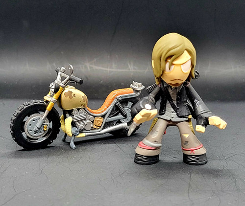 Funko Mystery Minis The Walking Dead series 4 Daryl Dixon with Knife & Crossbow with Daryl's bike brown variation for 2016. The Daryl Dixon is 1/24 figure. Daryl Dixon is a fictional character from AMC's horror drama series The Walking Dead portrayed by actor Norman Reedus. He appears as a major character in The Walking Dead and as the titular character of its spin-off series The Walking Dead: Daryl Dixon.