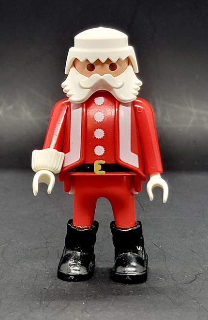 Geobra the German manufacture of Playmobil 1986 Santa Claus 3-inch tall figure for ages 3+. The figure is wearing a red Santa suit and black boots and belt. Santa is missing his hat and accessories.
