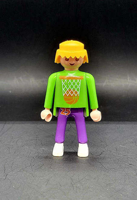 Playmobil GEOBRA PLAYMOBIL 1992 3867 Street Hoops Set 3" Figure (Part #3000650), front view of a blond toy basketball figure wearing a bright green hoop-print shirt, purple number 25 shorts, and white shoes