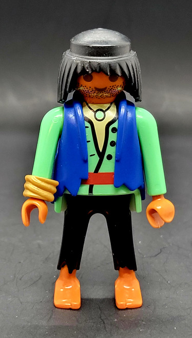Geobra the German manufacture of Playmobil 2002 pirate figure (part #3009530) from 3127 Pirates Superset 3-inch tall figure for ages 3+. The figure is wearing a green shirt with blue vest and black pants. The figure is missing his red headband (part #30096640).