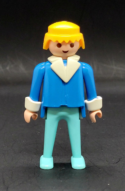 Geobra the German manufacture of Playmobil 1974 Policeman 3-inch tall figure for ages 4+. The figure is wearing dark blue shirt with white collar  and light blue pants. The policeman is missing his helmet and accessories.