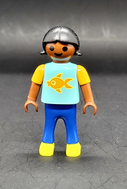 Playmobil PLAYMOBIL City Life Basic Figure Black Girl 2-inch Figure (Part #30112130), front view of a smiling figure wearing a silver helmet, turquoise fish-print shirt, blue pants, and yellow shoes.