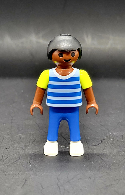 Geobra the German manufacture of Playmobil City Life School Bus black student 2-inch tall figure for ages 4+ from the 5940 City Life School Bus set. The figure is wearing a blue/grey striped shirt with yellow sleeves, blue pants and has black hair.