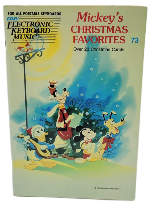 Hal Leonard Publishing Corporation Disney Mickey's Christmas Favorites Carols Electronic Keyboard Music Book, vintage cover featuring Mickey Mouse, Donald Duck, Goofy, and Pluto in a snowy scene, with over 20 Christmas carols for portable keyboards.