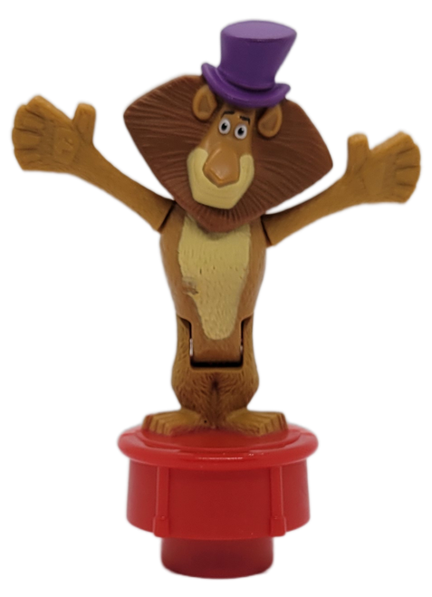 McDonald's Happy Meal toy of Alex the lion from the 2012 Madagascar 3: Europe's Most Wanted.  Alex is wearing a purple hat and stands on a red stand that makes him bend forward when pressed down. The US set consists of 6 different toys and was available May 25th to June 14th, 2012.