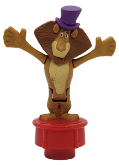 McDonald's Happy Meal Toy 2012 Madagascar 3 Europe's Most Wanted Alex the Lion (Loose), Alex the Lion toy wearing a purple top hat with arms raised on a red stand, shown against a white background.