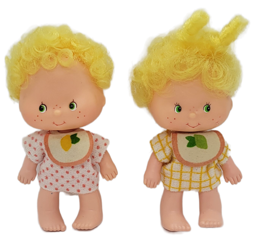 American Greetings 1979 Strawberry Shortcake 4-inch tall figures of Lem and Ada the twins. Lem is a boy and wears a green and yellow hat. His shirt has orange polka dots on it and a bib with a lemon on it. His diaper has yellow checks. Ada is a girl and wears a green and yellow hair bow and has two curls on top of her head. Her shirt has yellow checks and a bib with a lime on it. Her diaper has orange polka dots. Lem and Ada only appeared in the International Friends line. The figures were made in Hong Kong.
