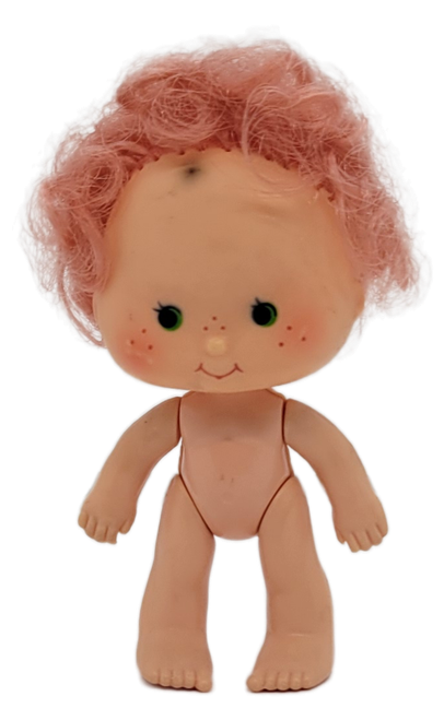 American Greetings 1979 Strawberry Shortcake 4-inch tall figure of Cherry Cuddler. Cherry Cuddler has pink hair and green eyes and is one of Strawberry Shortcake's baby friends. As a baby, she's smaller than the other dolls. The figure was made in Hong Kong.