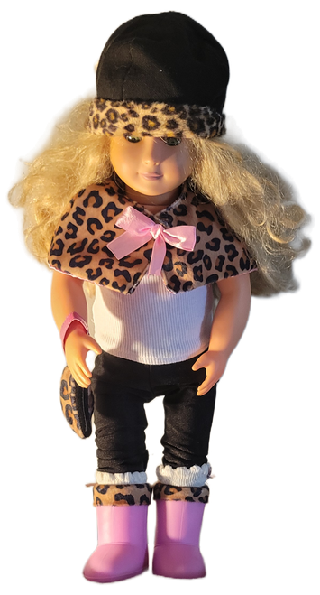 Our Generation 18-inch female doll with blonde curly hairstyle, a leopard-print cape with a pink bow, a matching hat and purse, and pink boots. The doll wears a casual white ribbed tank top paired with black leggings. Accessories include a coordinating leopard-print brim hat, a matching mini purse, and pink winter boots with faux-fur trim