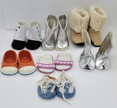 Collection of 7 pairs of shoes for 18-inch dolls. The lot contains 4 different boots, 2 sneakers and a pair of slippers. The silver boots are different with a pair with flat sole and the other pair having slight heel.