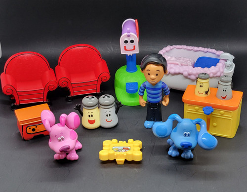 Just Play 2019 Nickelodeon Jr. show Blues Clues and You! collection of figures and pieces from the You Blues House playset and the Deluxe Play-Along Friends set. Includes poseable figures of Josh, Blue, and Magenta. Features iconic items like the Thinking Chair, Mailbox, Sidetable Drawer, and the Shaker family (Mr. Salt, Mrs. Pepper, and Paprika). Also comes with small play pieces including a bathtub with bubbles and a kitchen counter setup. The lot includes 11 pieces.
