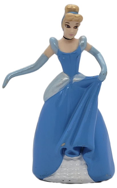 Disney's Cinderella PVC figure that stands 3.75-inches tall at highest point. She wears a blue ballgown with matching long gloves and a textured white base. Cinderella is holding her blue ballgown in the air with her left arm.