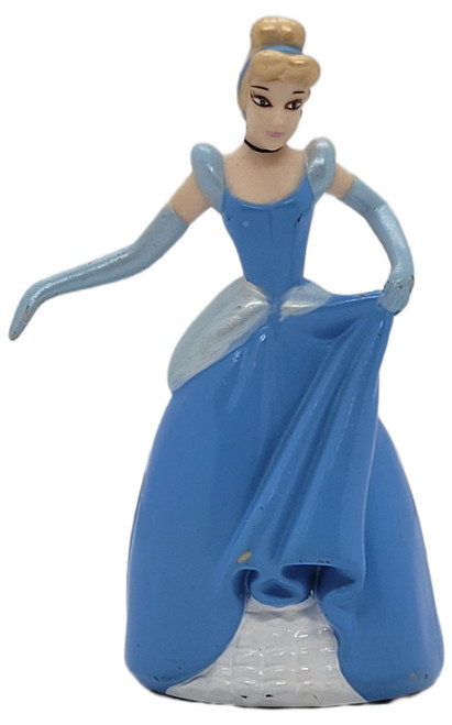 Disney Cinderella Holding Ballgown Left Hand 3.75" PVC Figure, blonde Cinderella in a blue ball gown and long gloves holding up her skirt with her left hand against a white background.