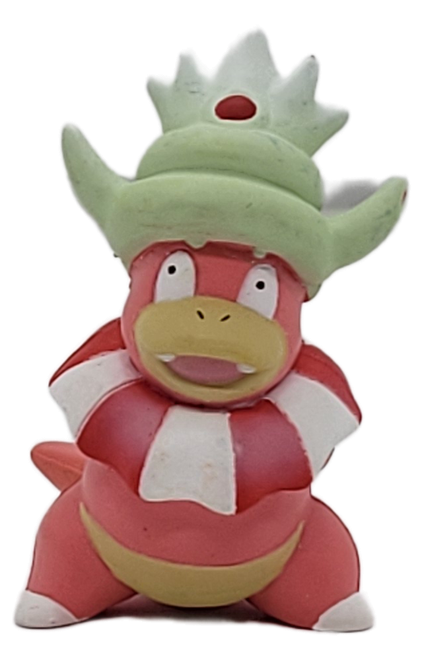 Pokémon Slowking 1.75-inch tall PVC figure by TOMY. This collectible feature toy is from the late 90s. Slowking is a bipedal Pokémon with a Shellder latched onto its head. It is primarily pink, with a pale yellow muzzle and scaled belly. This figure was made in China for ages 4+.