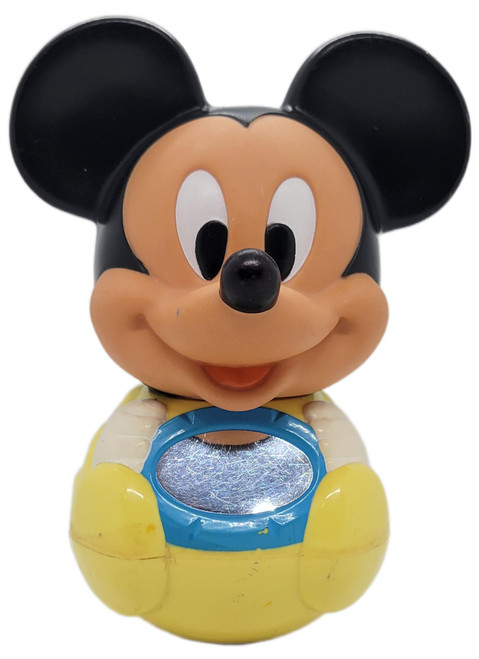 Disney 1984 Mickey Mouse Roly Poly Baby Toy Vintage Disney Wobble Toy, front view of a seated Mickey Mouse figure with black ears, yellow body, blue chest, and silver oval detail on a white background