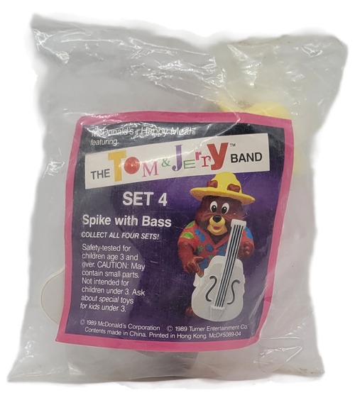 McDonald's Happy Meal toy of Spike with Bass from the 1990 Tom and Jerry Band series of toys. Spike is wearing a pink shirt with blue flowers and is wearing a yellow hat. Spike is playing a white bass The series of toys from the Tom & Jerry Band was available September 2-October 4, 1990.