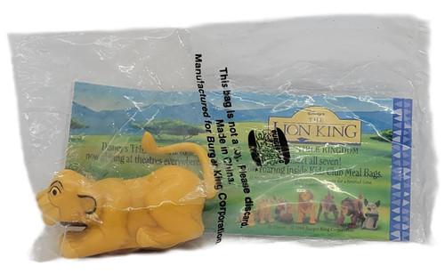Burger King Kids' Club 1994 Disney's The Lion King Young Simba (Value Book 2), vintage yellow Young Simba toy in its original clear plastic bag with The Lion King promotional packaging.