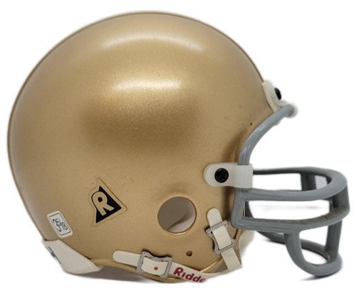 Riddell Notre Dame Fighting Irish Gold Mini Football Helmet – 3 5/8", side view of a miniature gold football helmet with a gray face mask and Riddell branding on a white background.