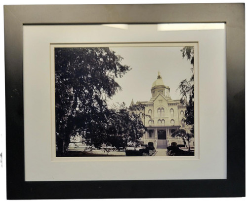 University of Notre Dame Golden Dome Framed Print – Fighting Irish Wall Art, 16" x 13", framed sepia-toned photograph of the Golden Dome building on the Notre Dame campus, bordered by trees and displayed with a cream mat and dark frame.