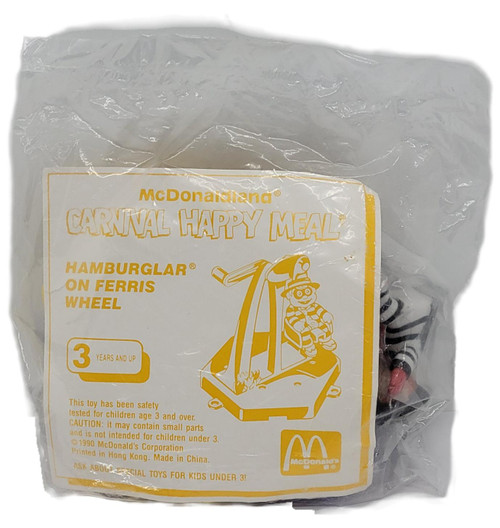 1990 McDonald's McDonaldland Carnival Happy Meal Hamburglar on Ferris Wheel Toy Sealed, vintage Happy Meal toy in its original clear plastic packaging with a yellow-and-white instruction card showing Hamburglar riding a Ferris wheel.