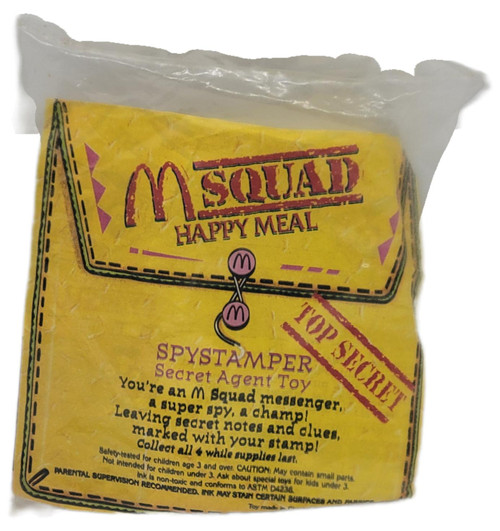 1993 McDonald’s M-Squad Happy Meal Spystamper Secret Agent Toy Sealed, vintage yellow McDonald’s package shown in its clear sealed bag with M-Squad and Spystamper Secret Agent Toy graphics.