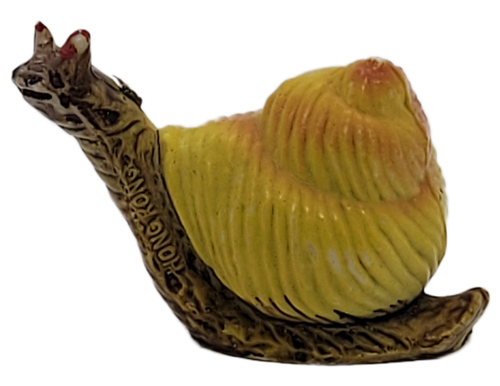 Hard plastic snail figurine with yellow shell and Hong Kong marking on neck