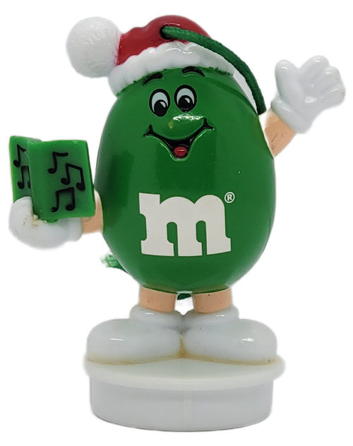 Front view of 1995 Green M&M Christmas caroler ornament holding a songbook