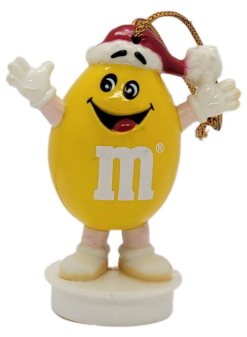 Front view of 1988 Yellow M&M Christmas ornament wearing a Santa hat