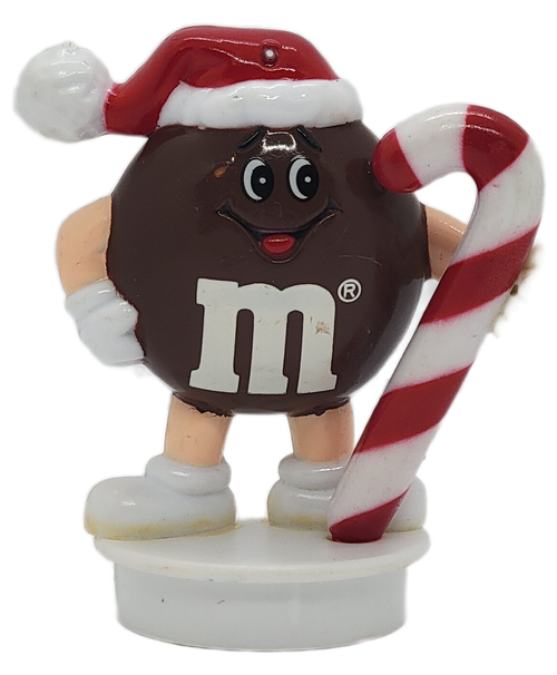 Front view of 1992 Brown M&M Christmas ornament holding a candy cane