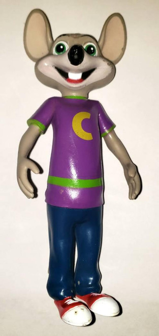 Chuck E. Cheese Wearing Purple Shirt Toy Figure, colorful cartoon-style toy figure with large ears, big green eyes, a wide smile, wearing a purple shirt with a yellow 'C', blue pants, and red shoes.