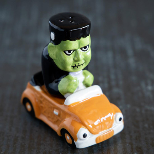Cracker Barrel Frankenstein In Car Salt and Pepper Shaker Set, spooky Halloween-themed ceramic figurine of Frankenstein driving an orange car.