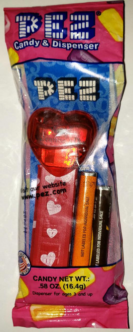 PEZ Red Crystal Heart 'Happy Valentine's Day' Pez Dispenser, candy and dispenser set with a red heart-shaped dispenser and two small batteries.