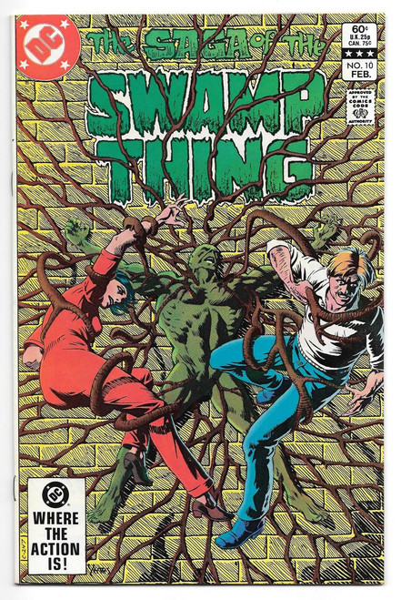 DC Comics Saga of the Swamp Thing #10 Comic Book, cover illustration of Swamp Thing entangled with two humans against a yellow brick wall background.