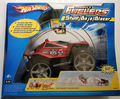 Hot Wheels Formula Fuelers Stunt Baja Blazer Vehicle, red toy car with stunt wheel design inside colorful packaging.
