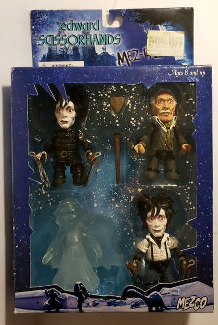 Mezco Toyz Edward Scissorhands Mez-itz 4 Pack Toy Figure Set, collectible figures of Edward Scissorhands, the inventor, Kim, and a ghostly figure, in a decorative winter-themed box.