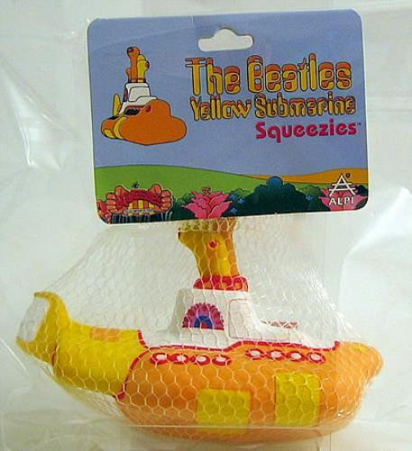 ALPI The Beatles Yellow Submarine Squeezies - Yellow Submarine, plush toy in the shape of the yellow submarine from The Beatles' Yellow Submarine animated film, packaged in a mesh bag with a colorful backing card.