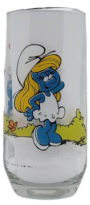 Vintage 1982 Smurfette Smurf glass tumbler. These were available at Hardee's fast food restaurants. The glass features Smurfette posing with 4 Smurfs staring at her with hearts above them.  The Smurfs (French: Les Schtroumpfs; Dutch: De Smurfen) is a Belgian comic franchise centered on a fictional colony of small, blue, human-like creatures who live in mushroom-shaped houses in the forest.