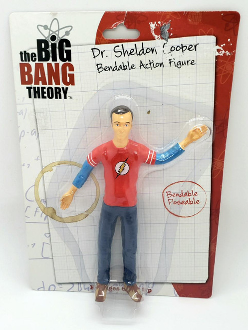 Warner Bros. The Big Bang Theory Dr. Sheldon Cooper Bendable Action Figure, bendable poseable doll in a red T-shirt with a lightning bolt logo, blue pants, and brown shoes, in packaging with graph paper background and hand-written style labels.