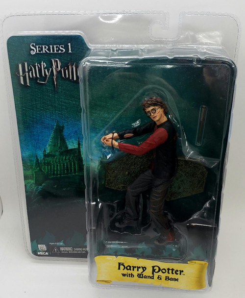 NECA Series 1 Harry Potter with Wand & Base Action Figure, damaged packaging, featuring a detailed Harry Potter figure wearing glasses and a black and red outfit, posed in a crouching stance with a wand in hand, set against a broomstick background.