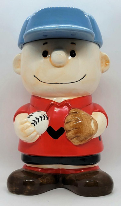 Benjamin & Medwin Peanuts 'Charlie Brown' Cookie Jar, ceramic cookie jar featuring a depiction of Charlie Brown with a blue hat, red shirt with a black heart, holding a baseball in one hand and a mitt in the other.